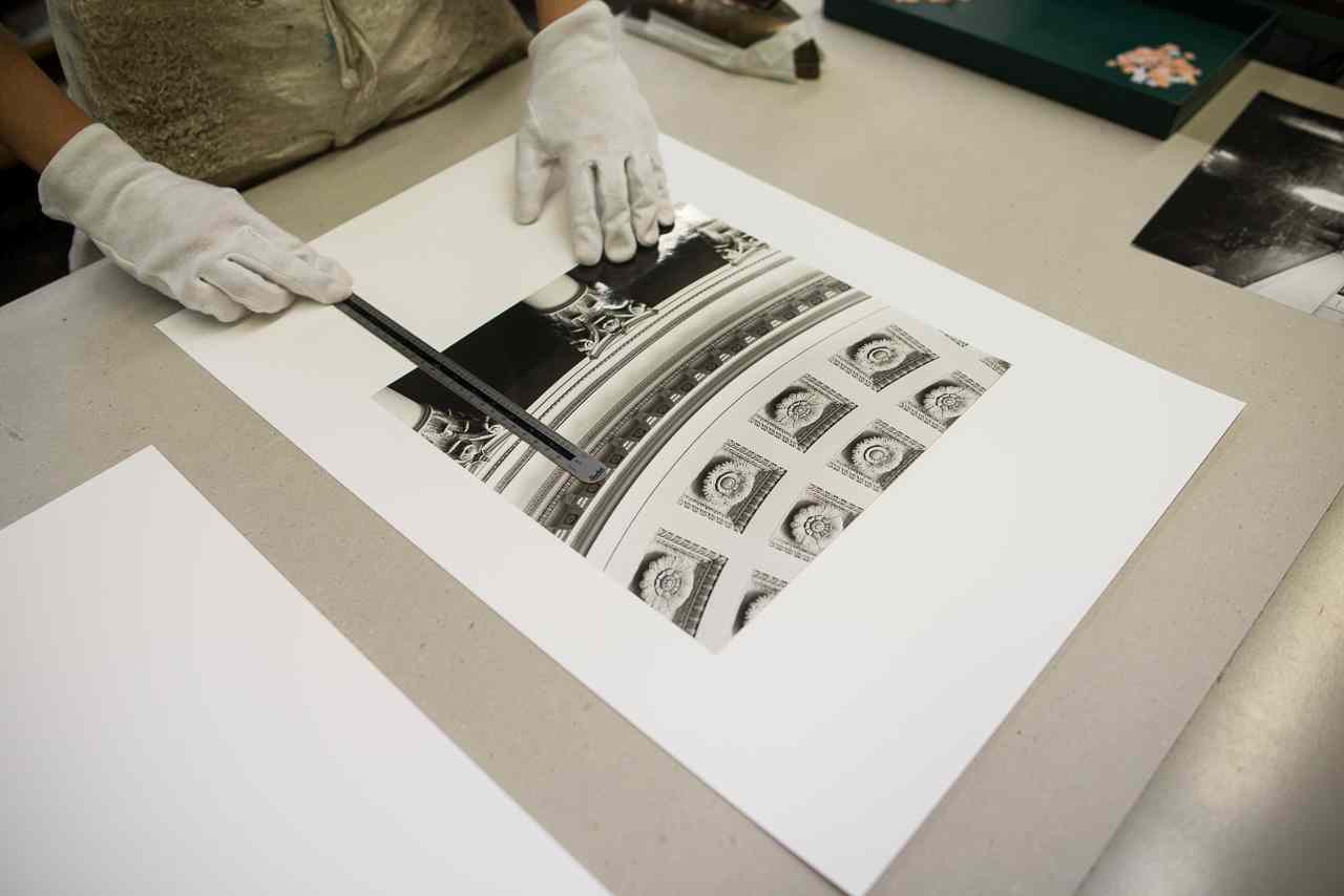 Photographs are mounted in the bookbindery for an exhibition